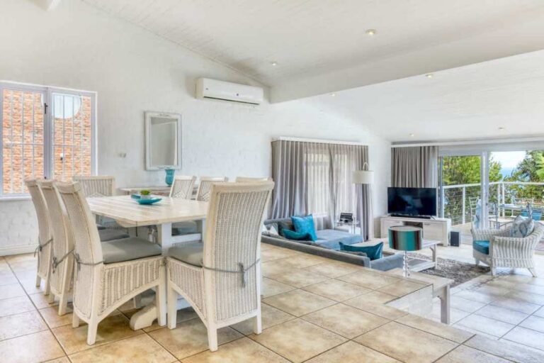 Airy open-plan living and dining area with coastal decor at Rontree Camps Bay