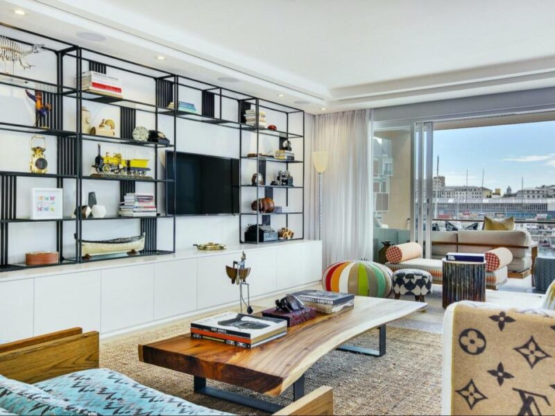 Stylish living area with custom shelving and marina-view balcony at Juliette 213