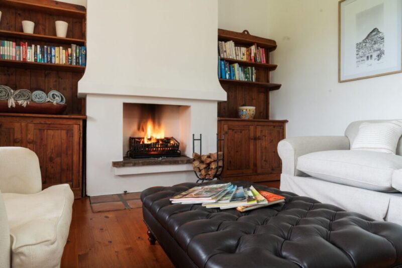 The Homestead cosy farmhouse lounge with fireplace and built-in bookshelves