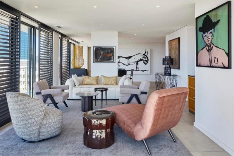 Contemporary designer lounge with curated artwork, floor-to-ceiling windows, and sophisticated open-plan living.