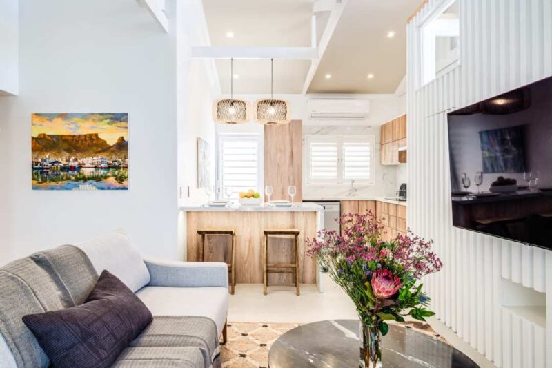 Modern open-plan lounge and kitchen with contemporary finishes and a bright, welcoming atmosphere.