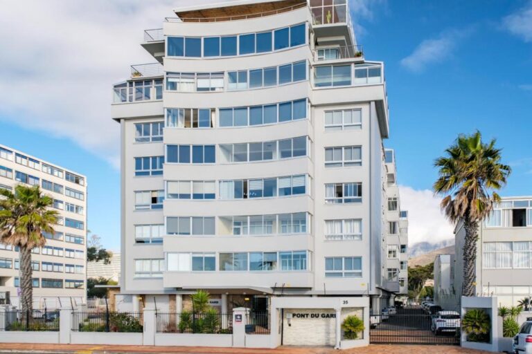 Modern seaside apartment block exterior with mountain views at Avaya Apartment