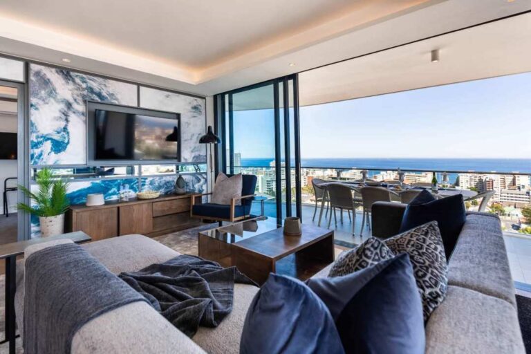 Designer lounge with ocean-facing balcony and statement wall at Attique Vue Penthouse