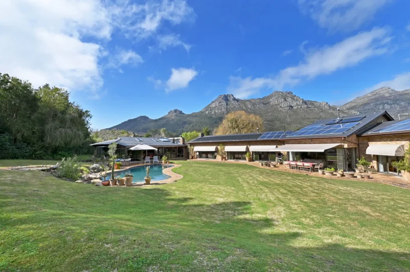 Forest Hill Retreat – Expansive landscaped grounds with a private swimming pool, mountain backdrop, and sweeping lawns that create a true countryside sanctuary in Hout Bay.