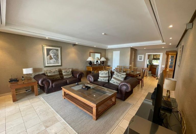 Parergon 006 – Spacious open-plan lounge and dining area featuring elegant contemporary furnishings, creating a warm and inviting space that flows effortlessly through to the fully equipped kitchen and private marina-facing terrace.