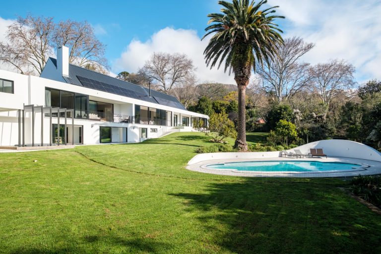 Villa Linea – Expansive landscaped gardens surround the villa's private swimming pool, creating a tranquil Constantia sanctuary framed by mature trees and magnificent mountain scenery.