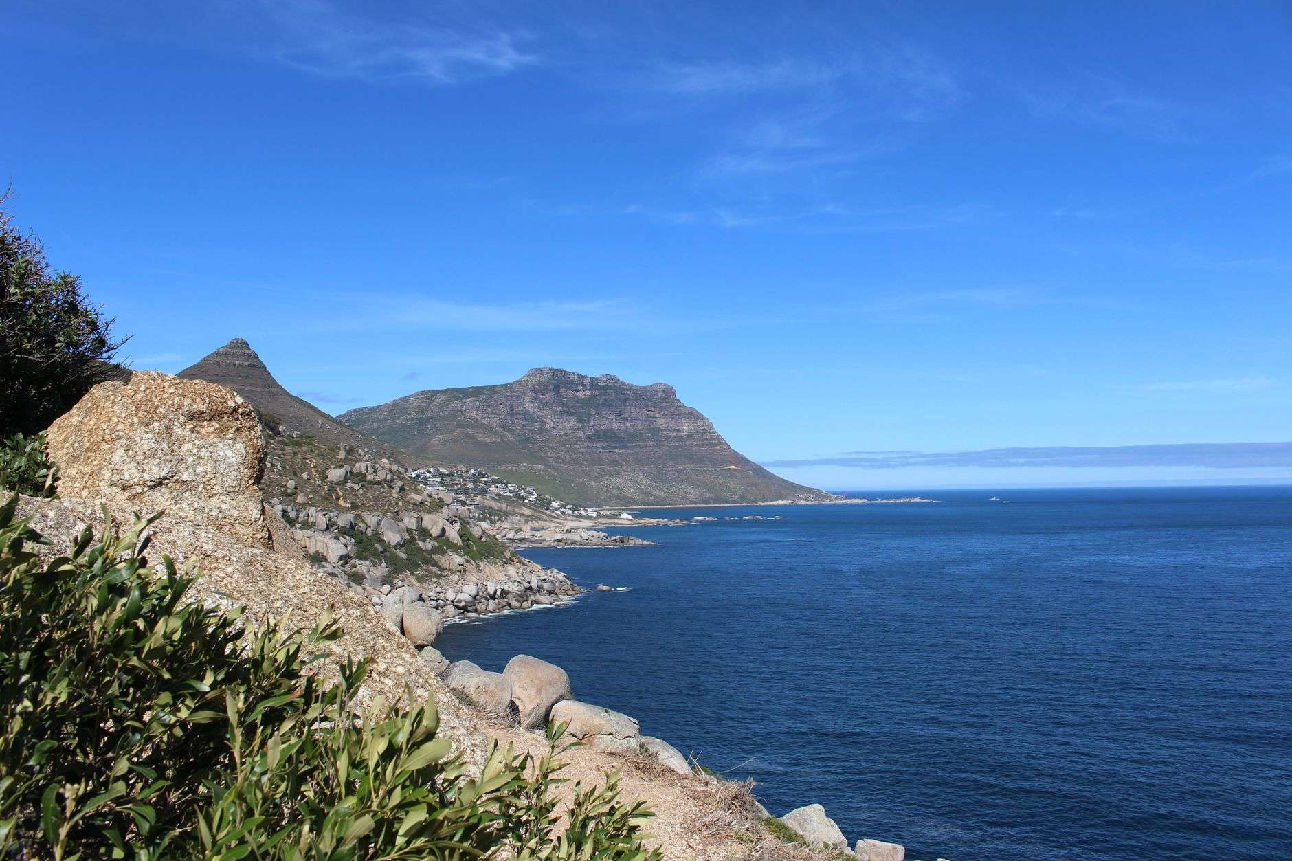 Cape Town’s Atlantic Seaboard with Table Mountain and coastline under clear blue skies.