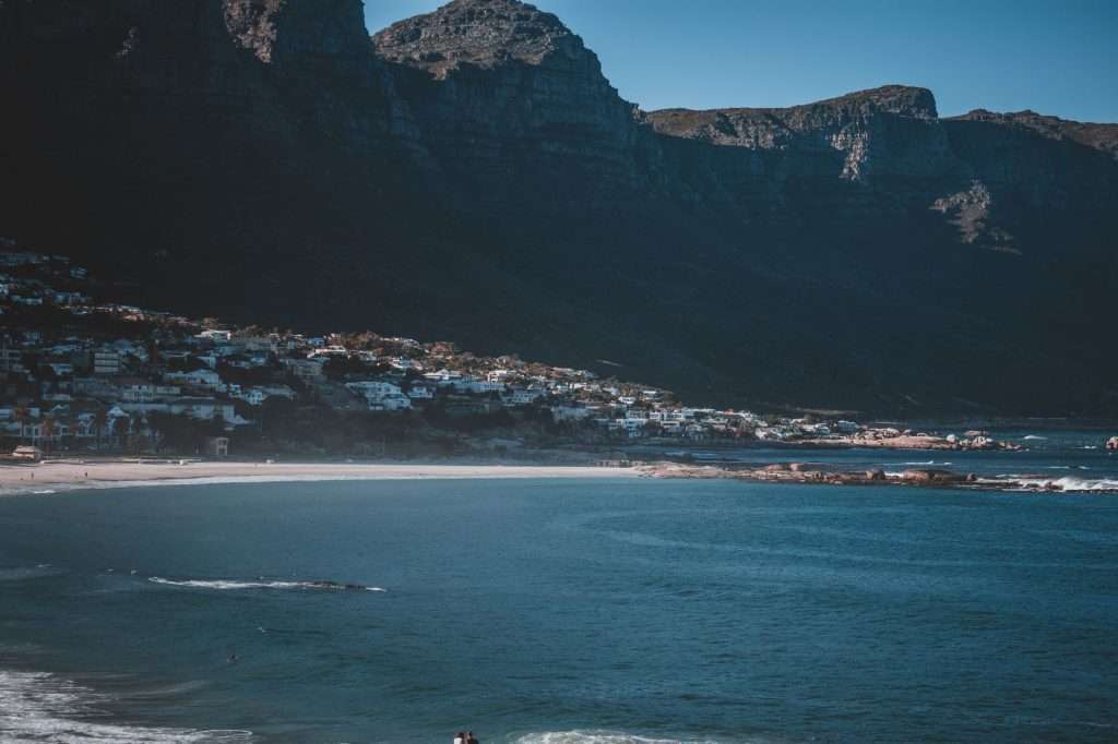Camps Bay beach with the Twelve Apostles mountains and ocean backdrop.