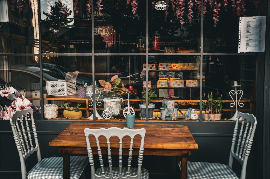 Quaint café setup with wooden table and chairs, plants, and decor in Taşova, Amasya, Türkiye.