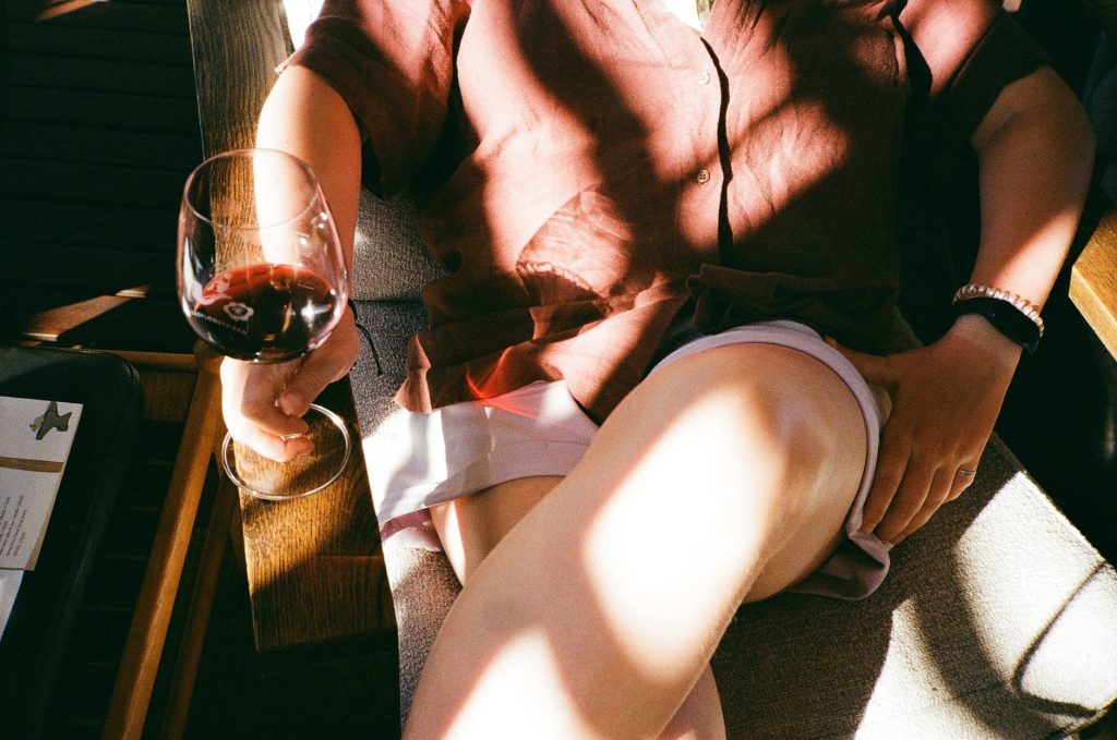 Person relaxing with red wine in Franschhoek
