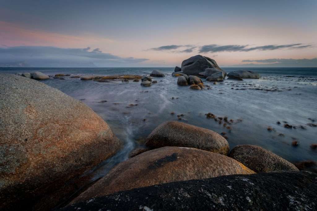 Rocky shoreline at sunrise in Cape Town, matching the secluded feel of Llandudno’s coves.