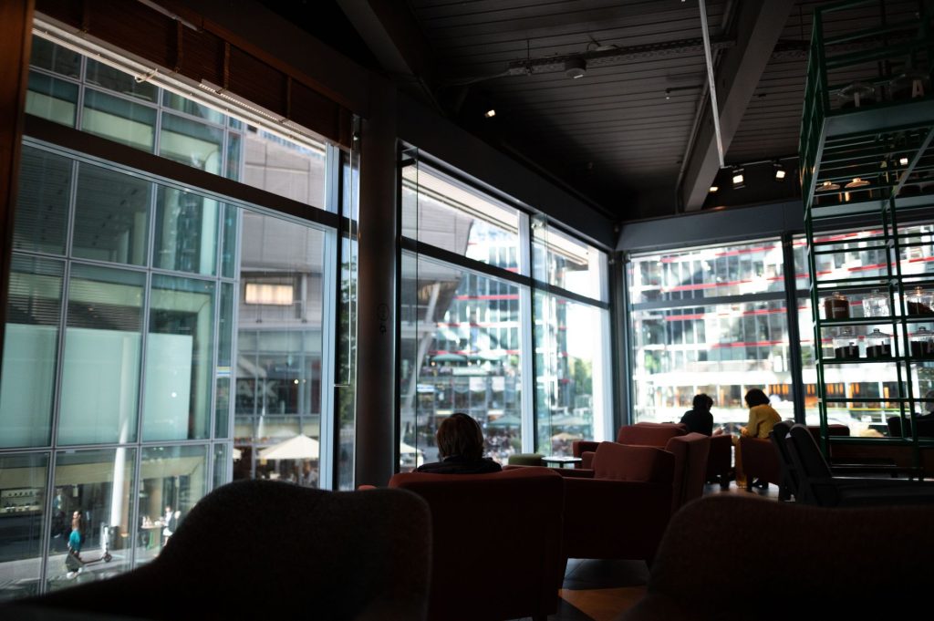 People seated in a contemporary café beside large windows