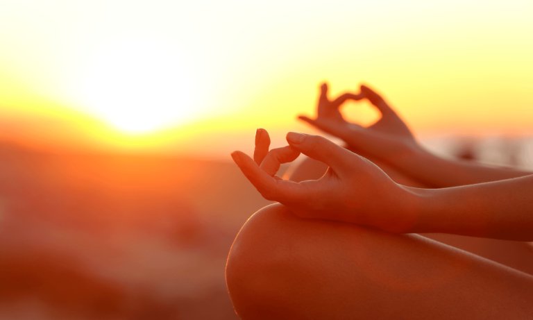 ands forming a heart at sunrise during a South African wellness journey