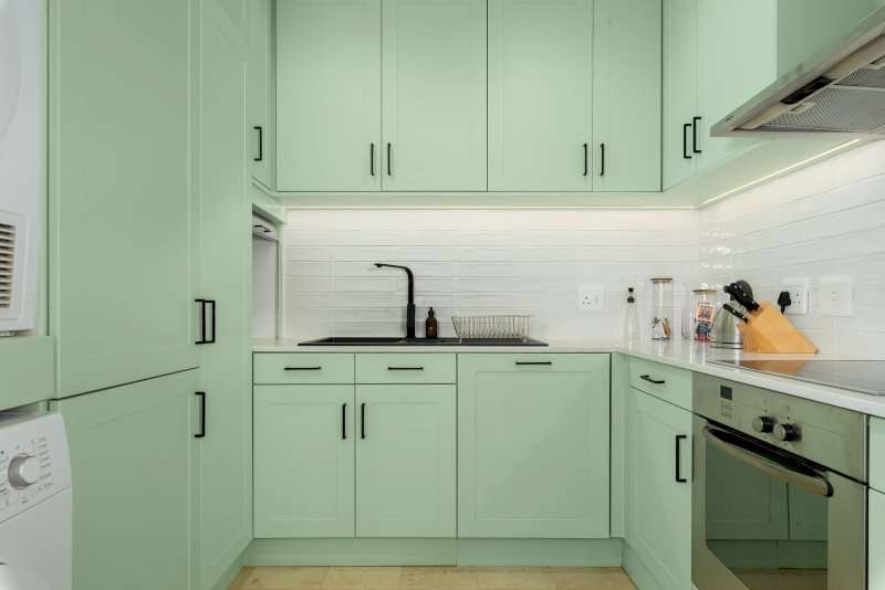 Carradale 3-Bed – Kitchen – Fresh, contemporary kitchen with soft green cabinetry, generous storage, modern appliances and a clean, elegant finish.