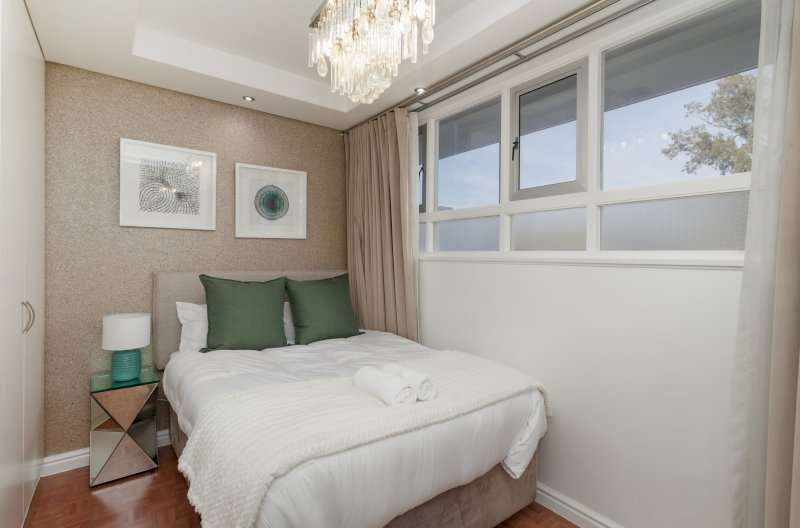 Mouille Point Seaside Stay – Second Bedroom – Comfortable double bedroom with soft neutral décor, built-in storage and contemporary finishes.