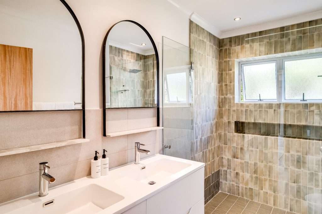Shoreline Views – Bathroom – Contemporary bathroom with double vanity, large walk-in shower and sophisticated neutral finishes.