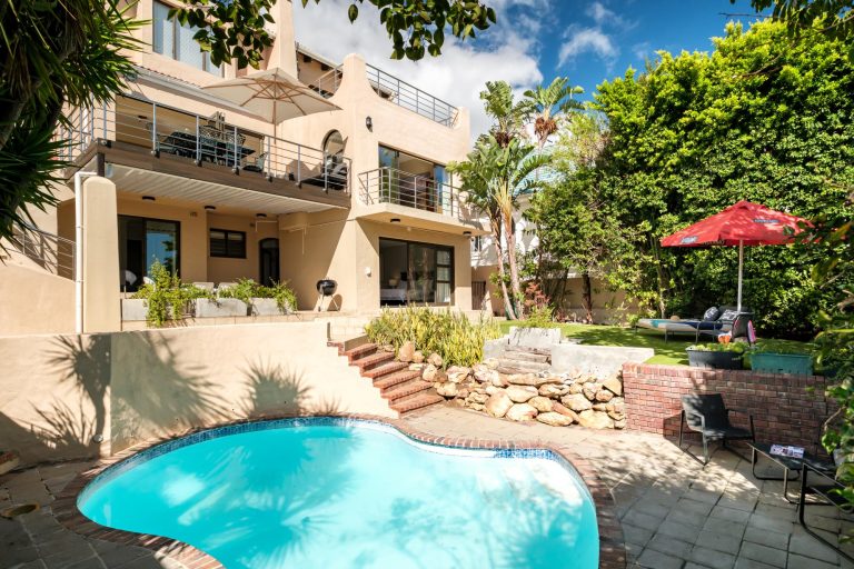 Kaya Eden – Exterior view of the multi-level home overlooking the private swimming pool, landscaped garden and sunny outdoor relaxation spaces.