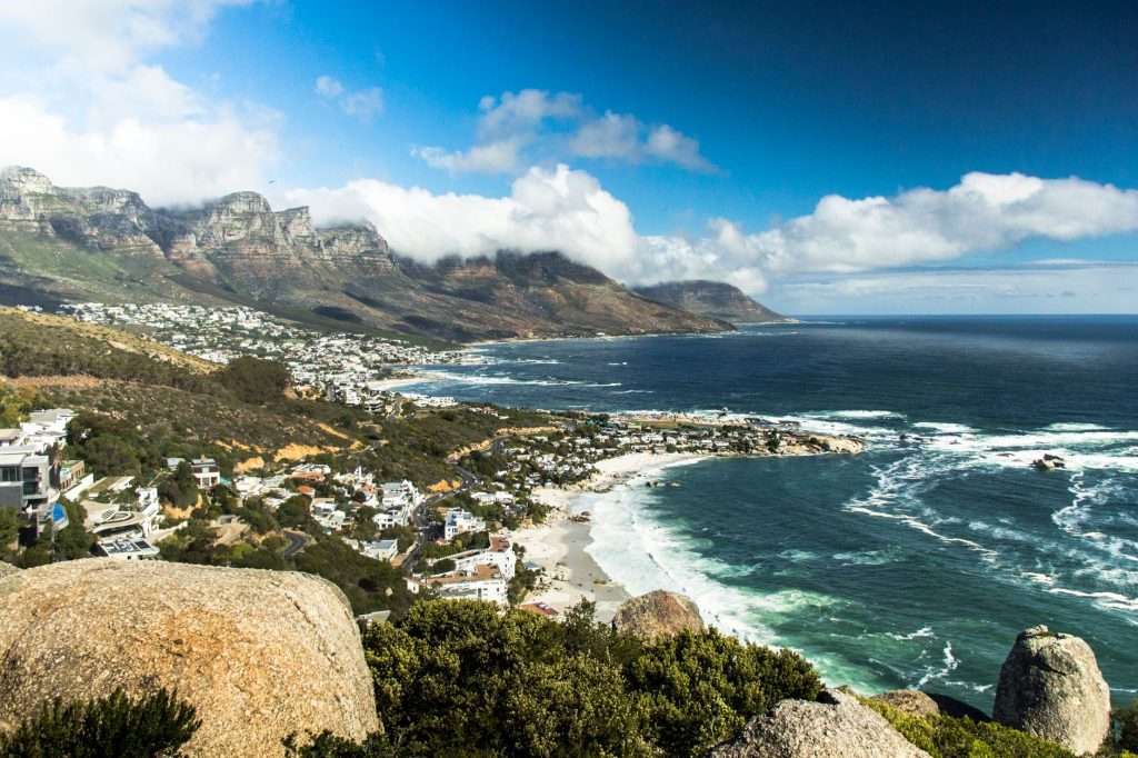 Cape Town coastline with ocean, mountains and beaches at sunset.