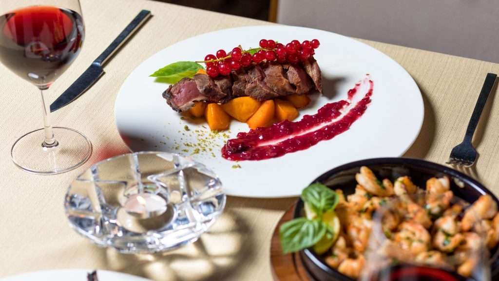 Delicious gourmet steak dinner with wine, served elegantly for fine dining.