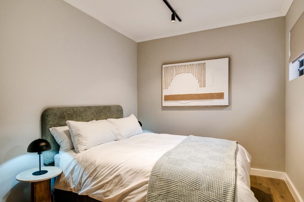 Kaya Eden – Peaceful double bedroom with soft neutral finishes, contemporary artwork and understated furnishings creating a calm retreat.