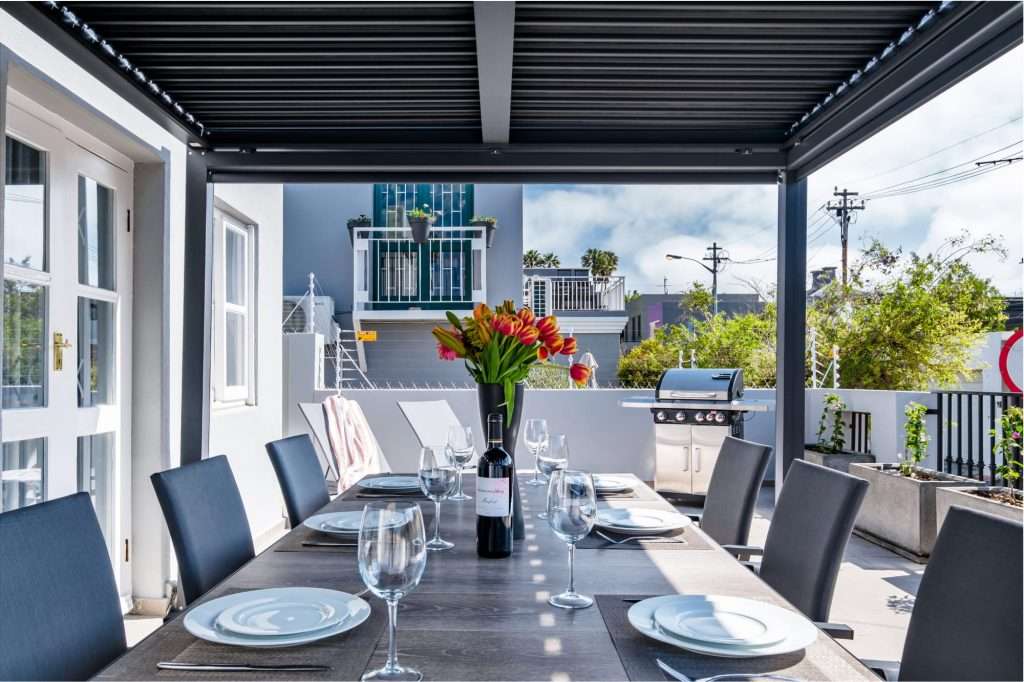 1. De Waterkant DW-001 – Outdoor Dining Terrace – Covered private terrace with a large dining table and built-in braai, creating a wonderful setting for alfresco meals and relaxed Cape Town evenings.