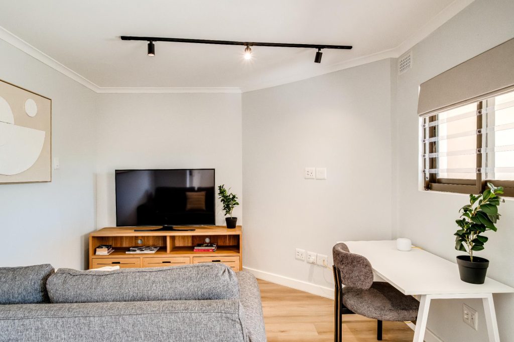 Kaya Eden – Separate television lounge or workspace with comfortable seating, a large-screen television and dedicated desk for working or studying.