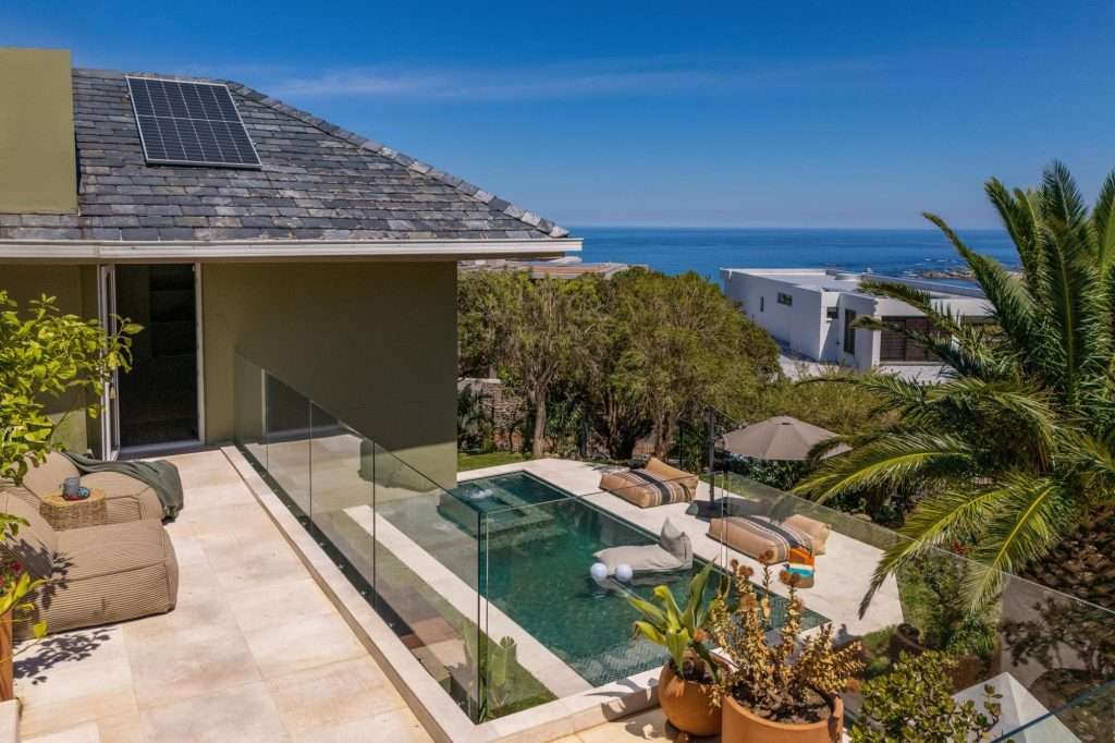 Kinvara Villa – Pool & Ocean Views – Elevated terrace overlooking the private swimming pool and garden, with beautiful views stretching towards the Atlantic Ocean.