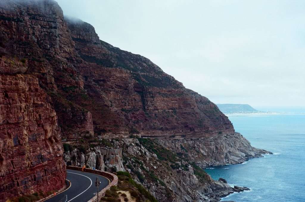Winding coastal road along cliffs near the ocean in South Africa.