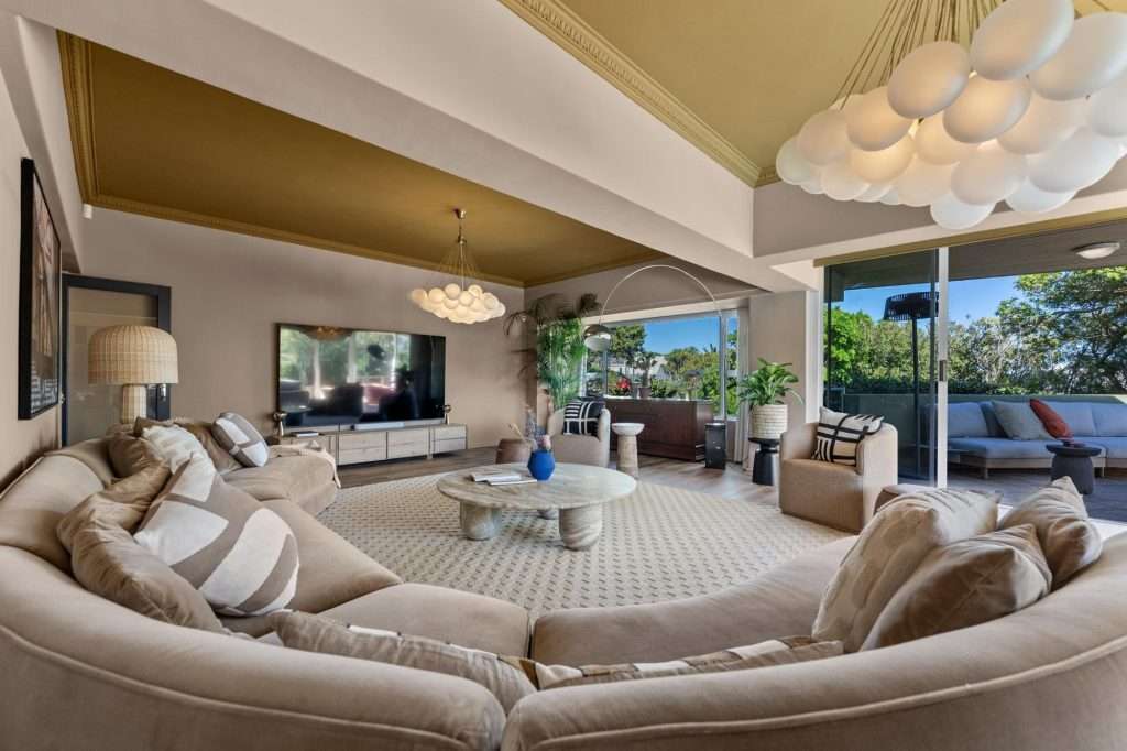 Kinvara Villa – Main Living Area – Generous open-plan lounge with plush curved seating, contemporary furnishings and wide glass doors connecting seamlessly with the outdoors.